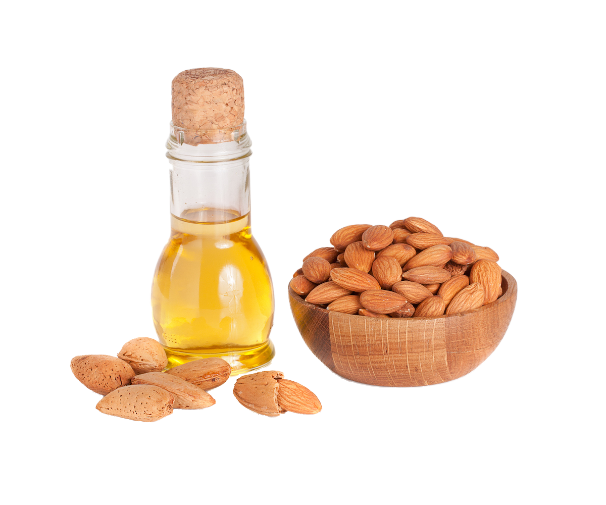 A small glass bottle with a cork filled with sweet almond oil, a small wooden bowl filled with almonds next to it.