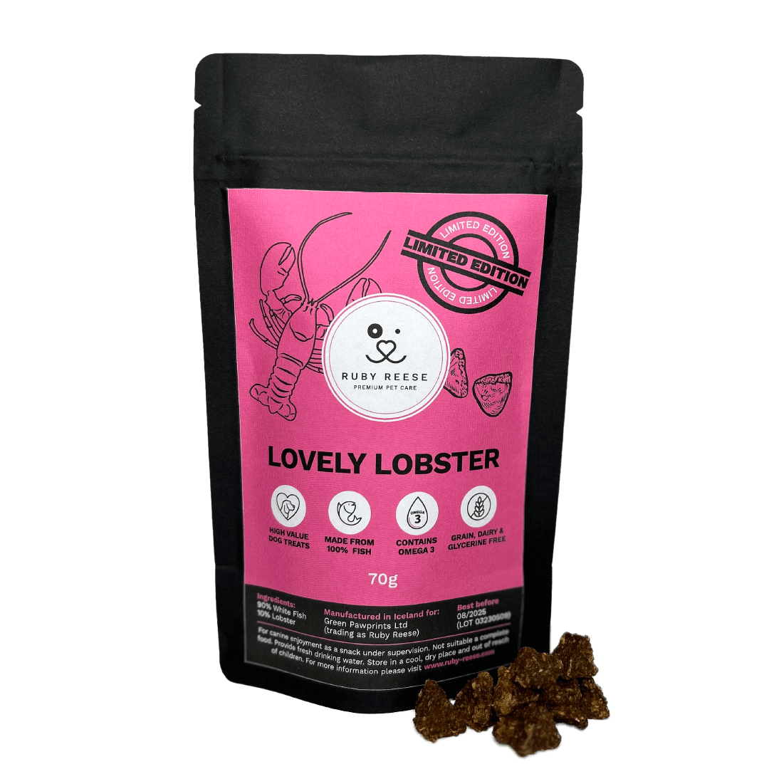 A black pouch of RUBY REESE LOVELY LOBSTER dog treats with a pink label and a ziplock with some treats spilled in front